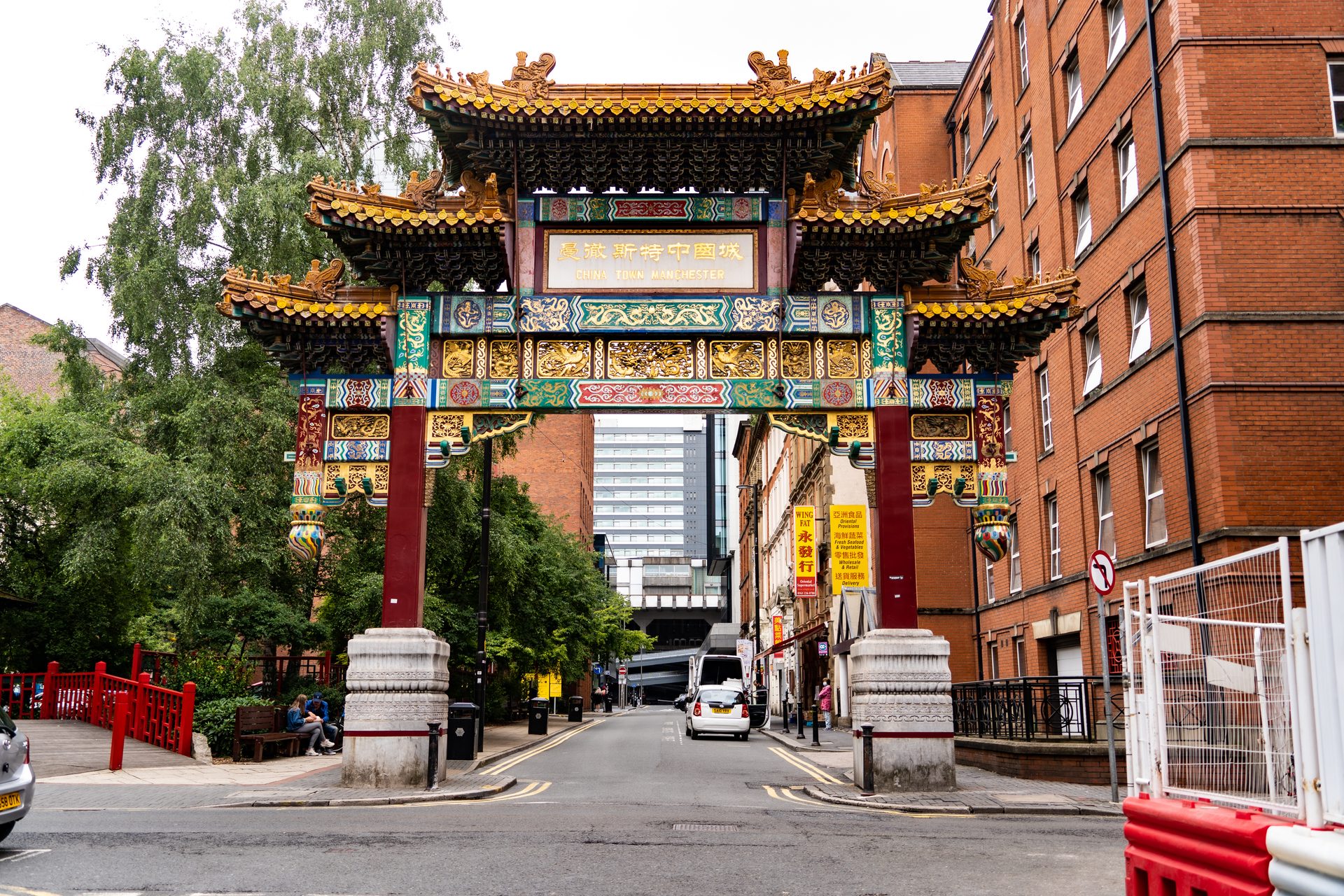 The red and gold Chinatown arch on Faulkner Street in Manchester, between red-brick buildings