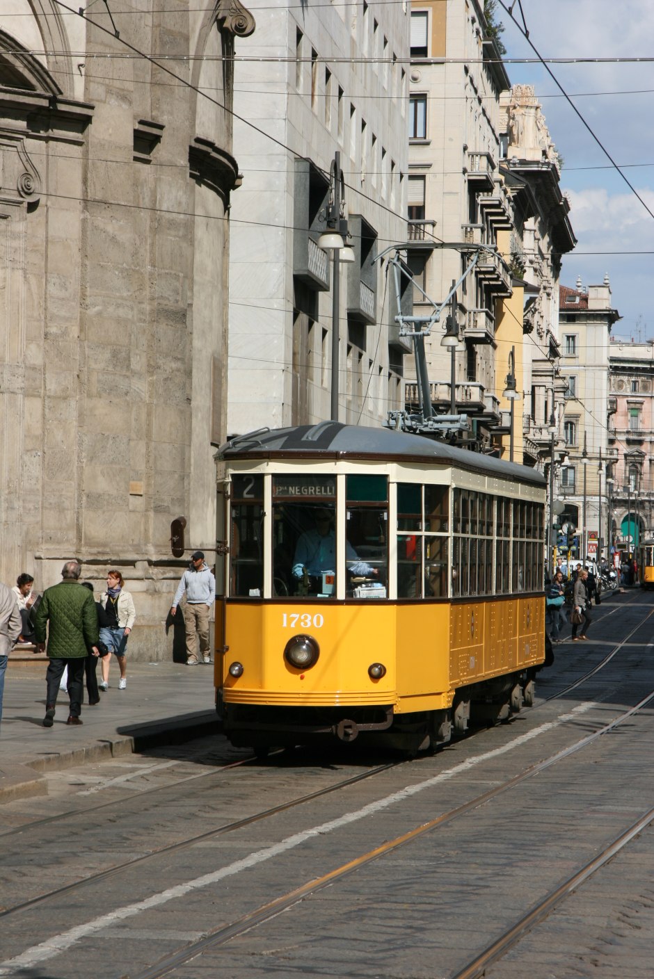 Eine gelbe Straßenbahn aus den 1920er-Jahren in der Via Torino im Zentrum von Mailand
